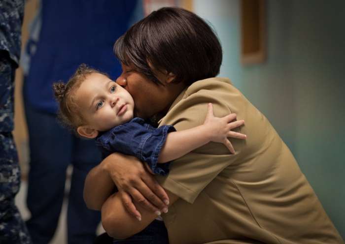 JON M. FLETCHER/The Times-Union Kimora McDonald, 23 months, gets a goodbye hug and kiss from her mother, Petty Officer 1st Class Tomeka McDonald, a Navy counselor, at the Child Development Center, an on-base day care at Jacksonville Naval Air Station.