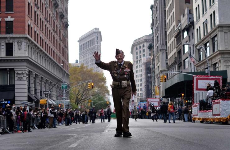 A US war veteran waves as he takes part in a Veterans Day Parade in New York. (Jewel Samad/AFP/Getty Images)